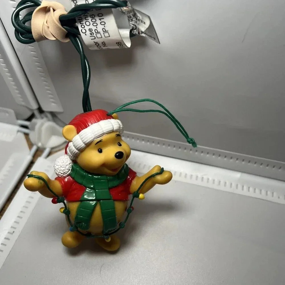 Disney Hallmark Ornament Winnie The Pooh Holding String of Lights Christmas